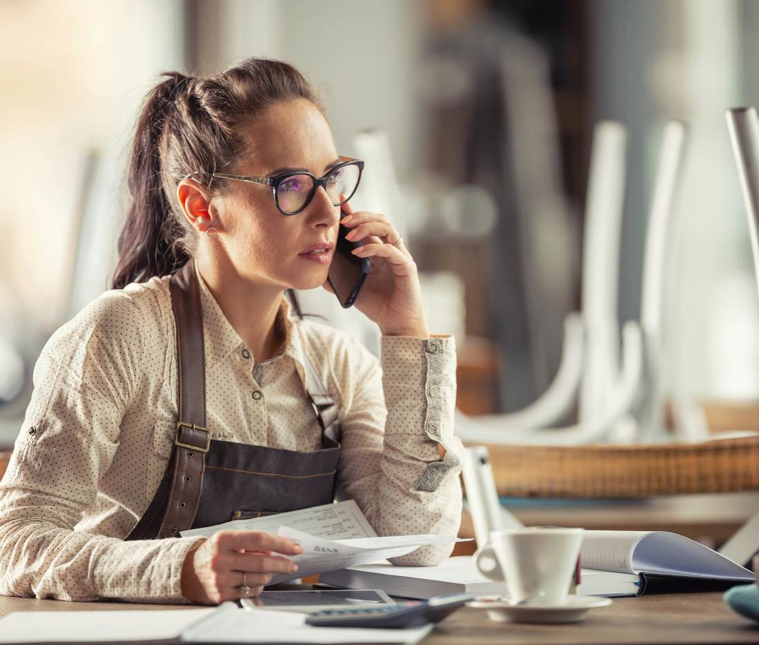 Café owner on the phone at her table